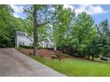 Well-maintained home boasts a long driveway and vibrant green lawn at 7750 Landowne Dr, Atlanta, GA 30350