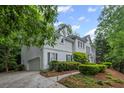 Stately two-story home with mature landscaping and an attached two-car garage at 7750 Landowne Dr, Atlanta, GA 30350