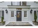 Elegant front door with decorative glass, sidelights, and black lanterns at 7750 Landowne Dr, Atlanta, GA 30350