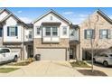 Charming townhome with a mix of stone and siding, a two-car garage, and a well-maintained driveway at 1388 Ben Park Way, Grayson, GA 30017