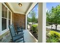 Comfortable covered front porch with rocking chairs and views of the neighborhood at 1156 Whisper Cove Dr, Buford, GA 30518