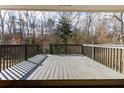Large back deck with wooded views provides ideal outdoor living space for entertaining at 3844 Davis St, Suwanee, GA 30024