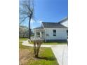 Inviting exterior view with a walkway leading to a charming light blue home and covered porch at 5191 Nw Emory Nw St, Covington, GA 30014