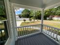 Cozy porch with white railings providing a comfortable outdoor space and neighborhood view at 5191 Nw Emory Nw St, Covington, GA 30014