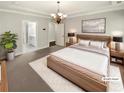 Spacious, virtually staged main bedroom with a large bed, modern furniture, and an ensuite bathroom at 108 Hickory Run, Canton, GA 30115