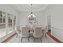 Bright dining room with a chandelier, large windows, neutral décor and seating for six at 1345 Hilltop Overlook Dr, Marietta, GA 30062