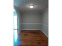 Cozy dining room featuring hardwood floors, wainscotting, updated paint, and an arched doorway at 732 Vinson Sw Pl, Atlanta, GA 30315