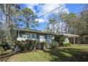 Side view of a cozy single-story home with a well-maintained lawn and mature landscaping at 3680 Larkspur Ter, Decatur, GA 30032
