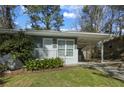 View of a well-kept home featuring a cozy front porch and a convenient carport at 3680 Larkspur Ter, Decatur, GA 30032