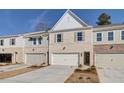 Attractive townhome with white brick, two car garage, and complementary architectural accents at 4525 Twinberry Dr, Powder Springs, GA 30127