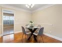 Charming dining room with hardwood floors, a glass table, and seating for four at 6980 Roswell Rd # G3, Atlanta, GA 30328