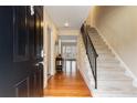 Inviting entryway with hardwood floors, stairs, and a glimpse of the bright living space ahead at 6980 Roswell Rd # G3, Atlanta, GA 30328