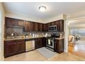 Modern kitchen featuring granite counters, stainless steel appliances, and dark wood cabinets at 6980 Roswell Rd # G3, Atlanta, GA 30328