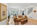 Bright living room with hardwood floors, plantation shutters, and a stylish leather sofa at 120 Candler Oaks Ln, Decatur, GA 30030