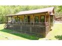 Inviting cabin exterior featuring a covered porch perfect for relaxing and enjoying the surrounding nature at 154 Knucklesville Rd, Rydal, GA 30171