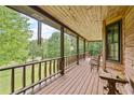 Relax on this covered porch offering scenic views, perfect for enjoying the outdoors in comfort at 154 Knucklesville Rd, Rydal, GA 30171