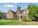Beautiful brick house with manicured lawn and mature trees at 1740 Doncaster Ne Dr, Atlanta, GA 30309