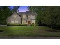 Charming brick home with a well-manicured front yard at dusk at 1740 Doncaster Ne Dr, Atlanta, GA 30309