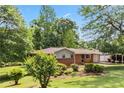 Beautifully landscaped front yard with a brick home, carport, and mature trees at 339 Diane Se Dr, Smyrna, GA 30082