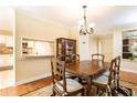 Traditional dining room showcasing hardwood floors, elegant furnishings, and convenient access to the kitchen at 3910 Ashford Lake Ne Ct, Brookhaven, GA 30319