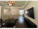 Spacious living room with wood floors, neutral walls, a ceiling fan and lots of comfortable seating at 3531 Lilly Brook Dr, Loganville, GA 30052