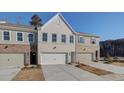 Beautiful new townhomes with a mix of brick and siding, complemented by pristine concrete driveways at 4517 Twinberry Dr, Powder Springs, GA 30127