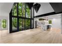 Bright, spacious living room boasting high ceilings, expansive windows with views, and an open-concept layout at 5020 Vallo Vista Ct, Atlanta, GA 30342