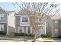 Charming two-story home with gray siding, brick accents, a cozy balcony, and well-maintained landscaping at 875 Venture Sw Way, Atlanta, GA 30331