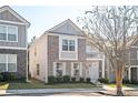 Charming two-story home with gray siding, brick accents, a cozy balcony, and well-maintained landscaping at 875 Venture Sw Way, Atlanta, GA 30331