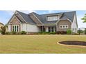 Beautiful home showcasing well-maintained landscaping and stylish architectural details at 170 Oakleigh Manor Dr, Fayetteville, GA 30215