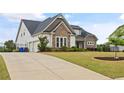 Lovely home with a long driveway and manicured lawn with a two car garage at 170 Oakleigh Manor Dr, Fayetteville, GA 30215