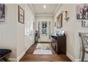 Inviting foyer with hardwood floors, a decorative rug, and coat closet at 170 Oakleigh Manor Dr, Fayetteville, GA 30215