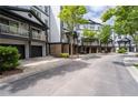 A view of a street with townhomes featuring covered balconies, garages, and attractive landscaping at 220 Semel Cir # 150, Atlanta, GA 30309
