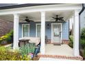 Inviting covered front porch with seating area, ceiling fans, and stylish decor at 3272 Stillwood Dr, Atlanta, GA 30354