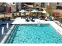 Community pool area with lounge chairs, umbrellas, water feature, and views of neighborhood townhomes at 3272 Stillwood Dr, Atlanta, GA 30354