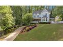 Charming two-story home with a landscaped yard, inviting front porch, and a classic picket fence at 4853 Ridgewood Creek Nw Dr, Acworth, GA 30102