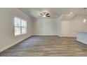 Spacious living room with hardwood floors, a ceiling fan, and a large window at 4534 Eastbrook Pl, Snellville, GA 30039
