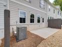 Rear exterior featuring neutral siding, white brick foundation, and a gravel landscape design at 4659 Larkfield Way, Powder Springs, GA 30127