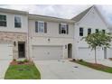Delightful townhome exteriors showcasing varied architectural styles, well-kept landscaping, and convenient two-car garages at 4659 Larkfield Way, Powder Springs, GA 30127
