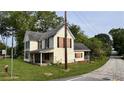 Street view of a two-story house with a covered porch and green lawn at 700 W College St, Bowdon, GA 30108