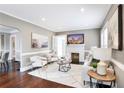 Cozy living room with fireplace, hardwood floors, and modern furnishings at 949 Hope Sw Dr, Atlanta, GA 30310