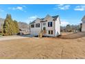 Beautiful two-story house with white siding, black shutters, a two-car garage, and a clear blue sky at 19 Bridgemill Dr, Douglasville, GA 30134