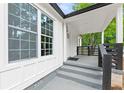 Inviting front porch with stylish gray painted steps, white trim, and dark wood railing, enhancing curb appeal at 4103 Brenda Dr, Decatur, GA 30035