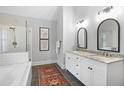 Bathroom boasts double vanity, tiled floors, frameless glass shower door and separate tub at 4314 Woodhaven Se Way, Smyrna, GA 30082