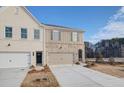 Modern townhome with light brick and siding, featuring an attached one-car garage at 4511 Twinberry Dr, Powder Springs, GA 30127