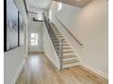 Bright foyer showcasing wood floors, staircase with wrought iron railings, and ample natural light at 4514 Eastbrook Pl, Snellville, GA 30039