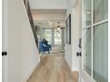 Inviting entryway featuring wood floors, a staircase, and a view into the stylishly furnished living room at 4514 Eastbrook Pl, Snellville, GA 30039