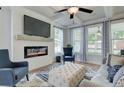 Cozy living room boasts a modern fireplace, coffered ceiling, and an array of windows for natural light at 4514 Eastbrook Pl, Snellville, GA 30039