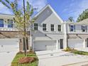 Stylish townhome showcases a two-car garage, gray brick exterior, and well-maintained lawn at 4651 Larkfield Way, Powder Springs, GA 30127