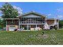 Spacious backyard featuring a screened in porch, open patio area, and stairs leading to the second level at 760 Oakdale Rd, Canton, GA 30114